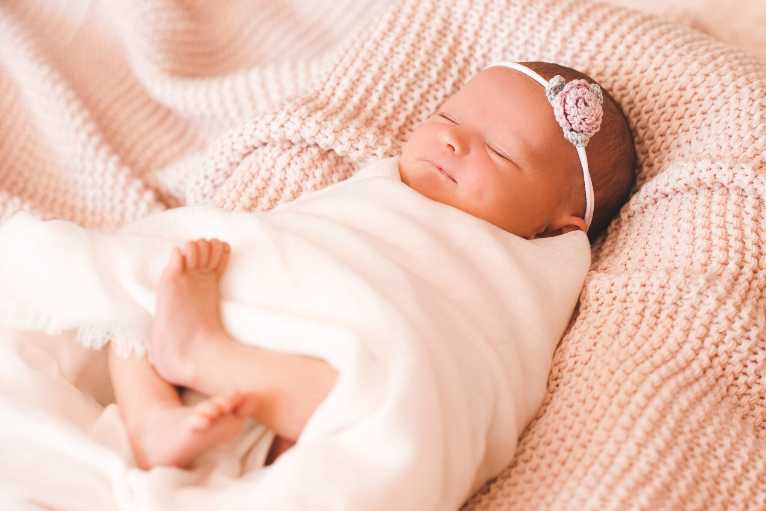 smiling cute baby girl sleeping swaddled in crib c 2022 11 17 15 04 48 utc scaled